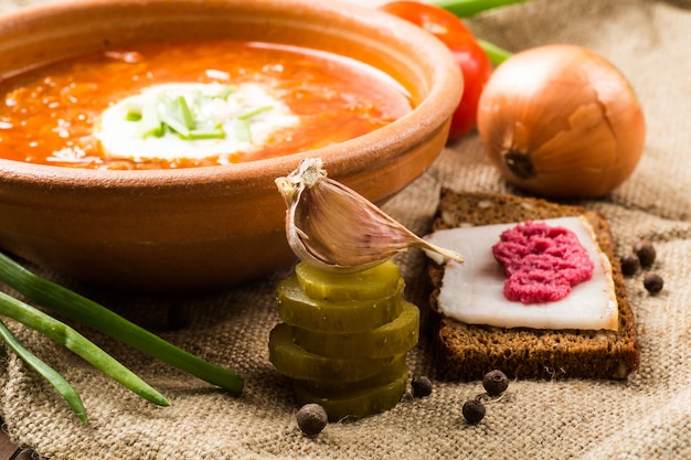 Ukrainian Lunch: soup, pickled cucumbers, garlic