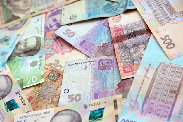 Ukrainian money bills close up big amount of hryvnia bills on table business and investment