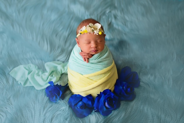 Ukrainian newborn child in the studio patriotic blue yellow colors during the war in ukraine a litt