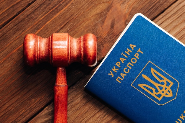 Ukrainian passport with a judge's gavel on a wooden table