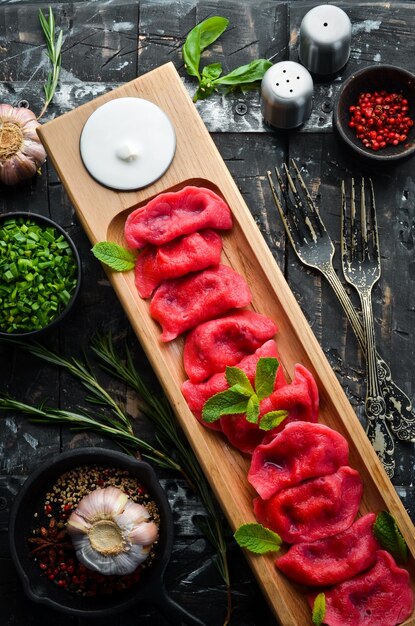 Ukrainian traditional food Red dumplings with cherries Top view Rustic style