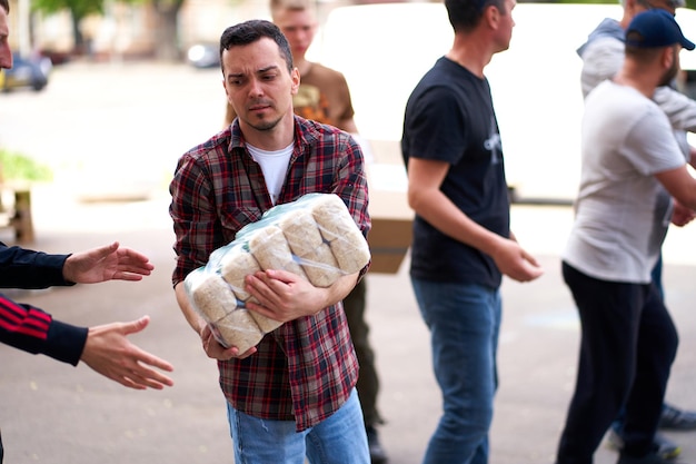 Ukrainian volunteers unloading boxes with humanitarian aid