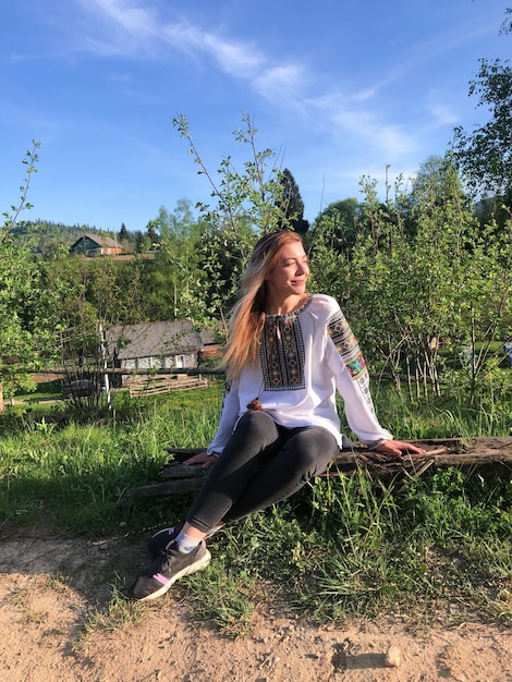 Ukrainian Woman in Embroidery Shirt in Carpathians Landscape