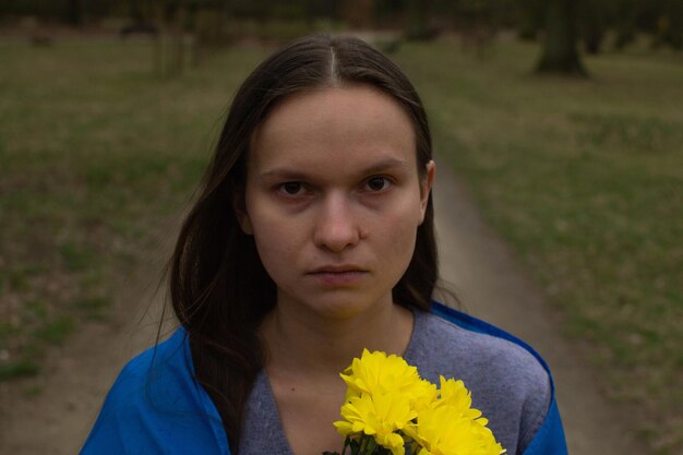 Ukrainian woman with flag and flowers