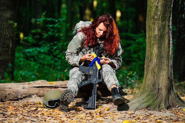 Ukranian female soldier in the forest