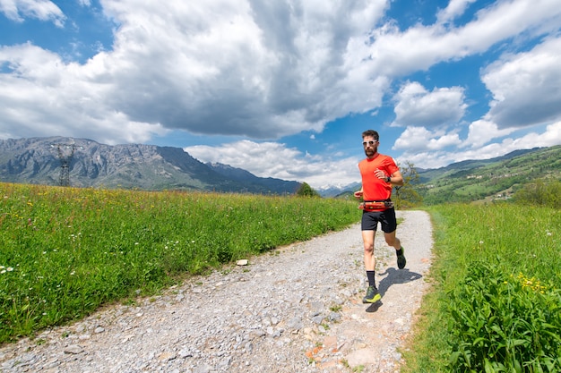 Ultra trail runner athlete prepares on a dirt road