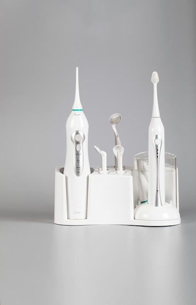 Ultrasonic toothbrush kit on a gray background. Closeup