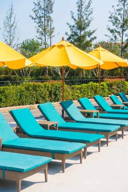 Umbrella and chair around swimming pool