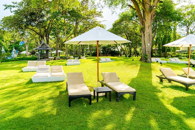 Umbrella and chair in garden for sun bathing or relax