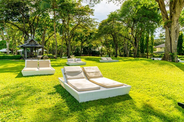 Umbrella and chair in garden for sun bathing