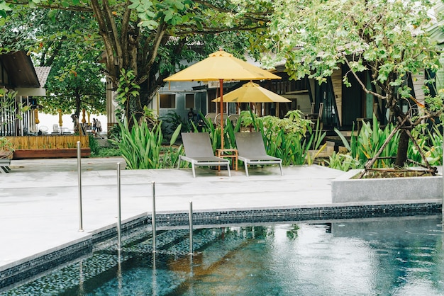 Umbrella and pool bed around swimming pool