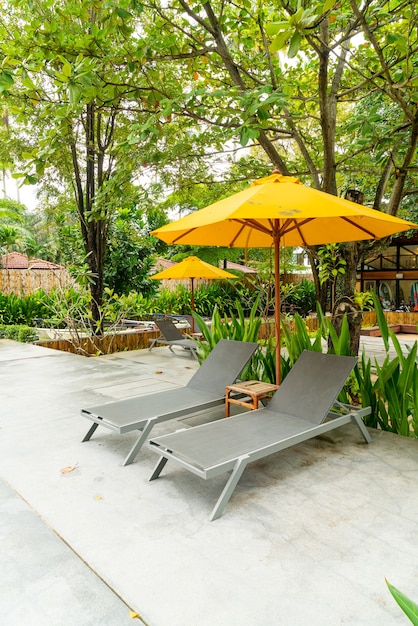 umbrella and pool bed decoration around swimming pool in hotel resort