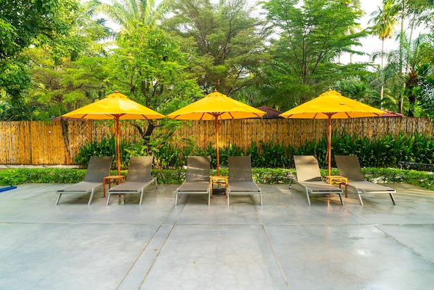 umbrella and pool bed decoration around swimming pool in hotel resort