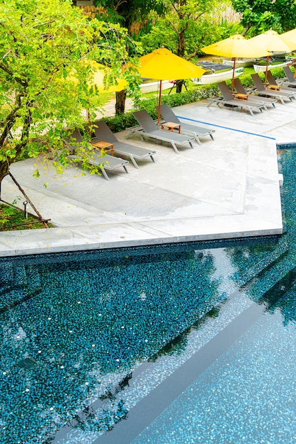 Photo umbrella and pool bed decoration around swimming pool in hotel resort