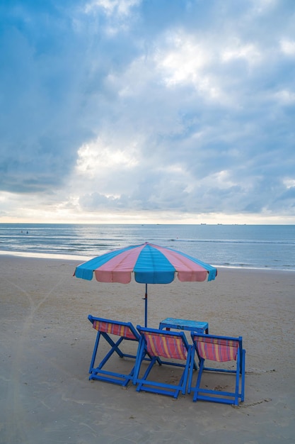 Umbrella and sun loungers to relax after bathing Vung Tau back beach Vietnam Pair of sun loungers and a beach umbrella on a deserted beach perfect vacation concept