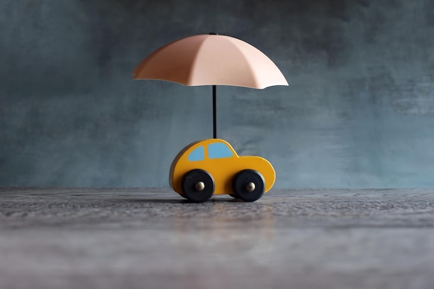 Ombrellone e auto giocattolo con spazio per la copia protezione dell'auto e concetto assicurativo