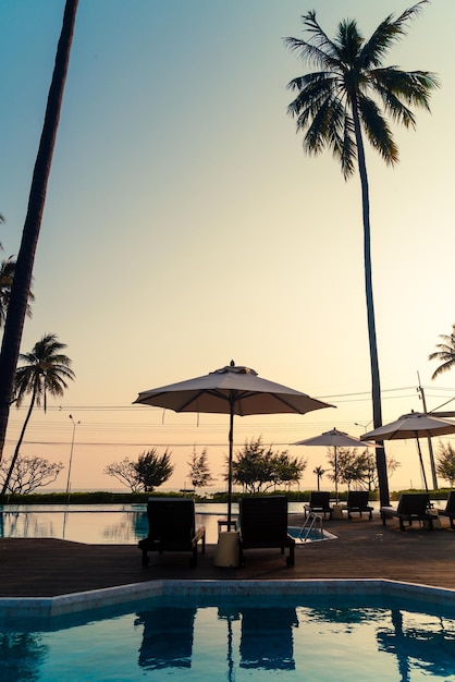 Umbrella with bed pool around swimming pool with ocean sea background