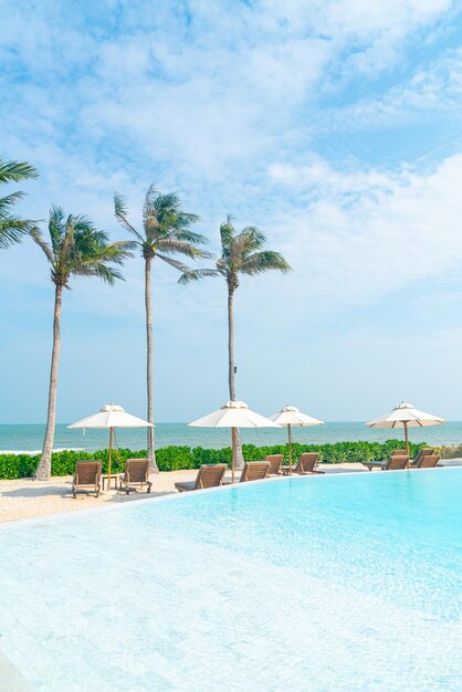 Umbrella with bed pool around swimming pool with ocean sea background