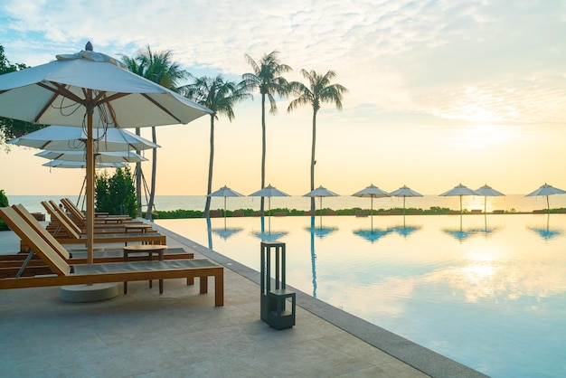 Umbrella with bed pool around swimming pool with ocean sea background