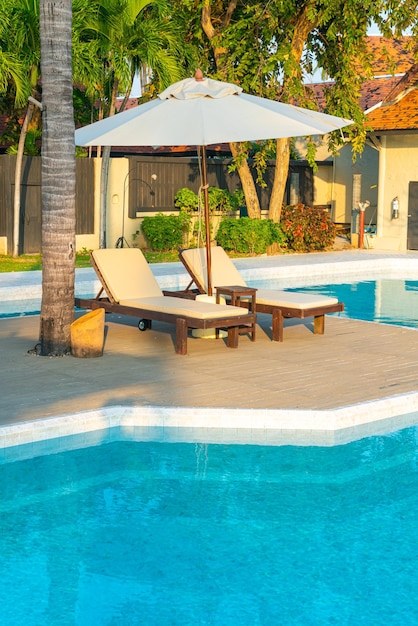 Umbrella with bed pool around swimming pool with ocean sea background