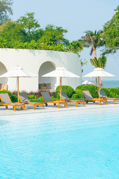 Umbrella with bed pool around swimming pool with ocean sea background