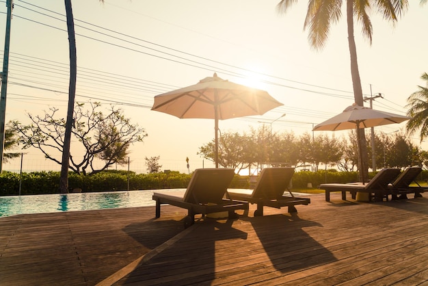 Umbrella with bed pool around swimming pool with ocean sea background