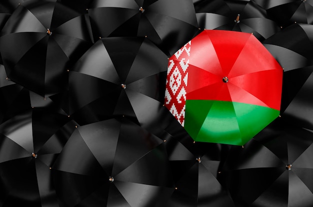 Umbrella with Belarusian flag among black umbrellas 3D rendering
