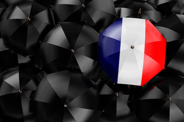 Umbrella with French flag among black umbrellas top view 3D rendering