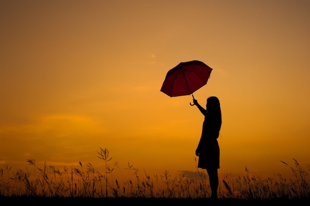 Umbrella Woman Standing and sunset silhouette