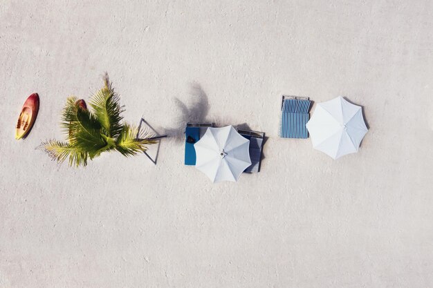 Umbrellas as a background from top view Beach and sand background from top view Summer seascape from air Bali island Indonesia Travel image