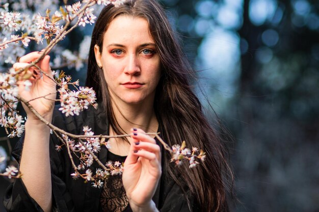 Photo unaltered imagery skincare dermatology beauty hispanic woman portrait with cherry blossom