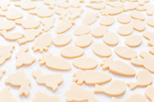 Unbaked Easter sugar cookies on a white table.