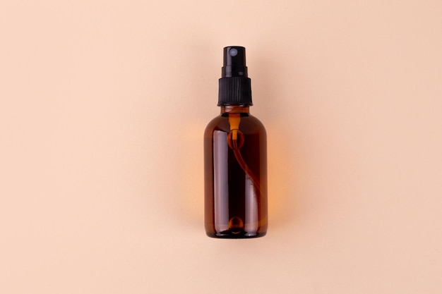 unbranded bottle with dispenser brown glass container with oil for body and hair mockup style design