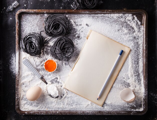 Uncooked black pasta and ingredients for homemade spaghetti 