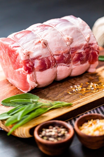 Uncooked boneless pork roast on the cutting board.