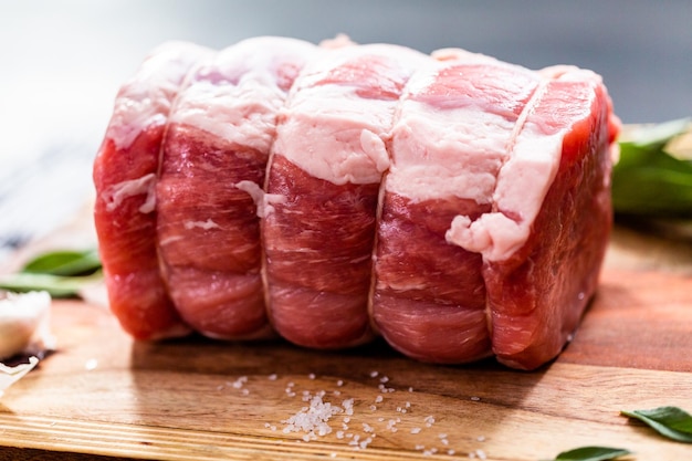 Uncooked boneless pork roast on the cutting board.