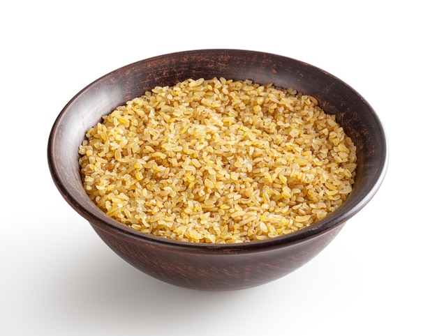 Uncooked bulgur in ceramic bowl isolated on white background with clipping path