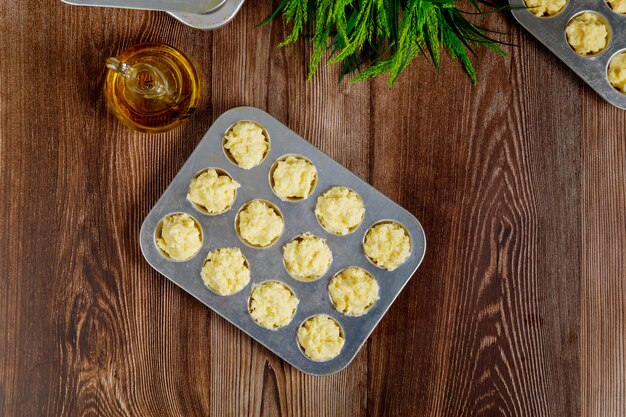 Uncooked cheese bread called chipa in baking tray.