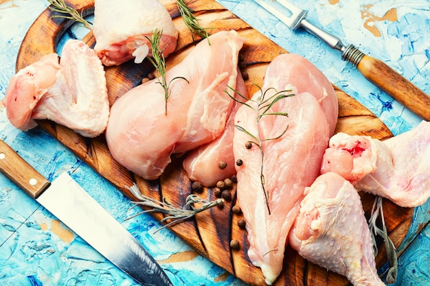 Uncooked chicken meat on cutting board