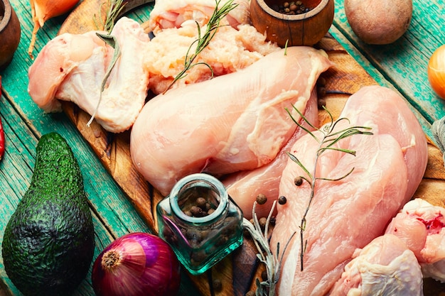 Uncooked chicken meat on cutting board