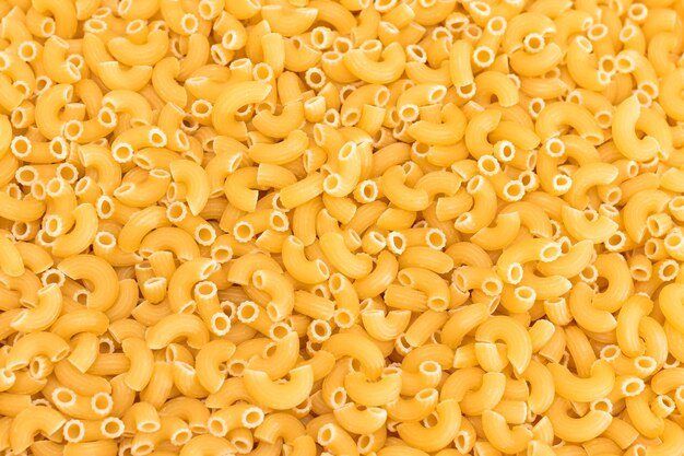 Uncooked chifferi rigati pasta background