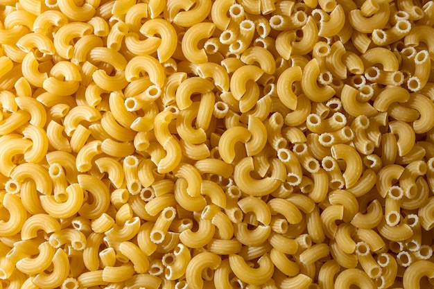 Uncooked chifferi rigati pasta background