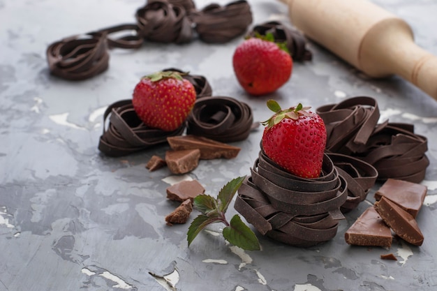 Uncooked chocolate pasta and strawberry 