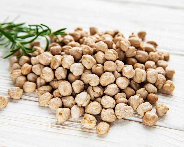 Uncooked dried chickpeas on a old wooden table