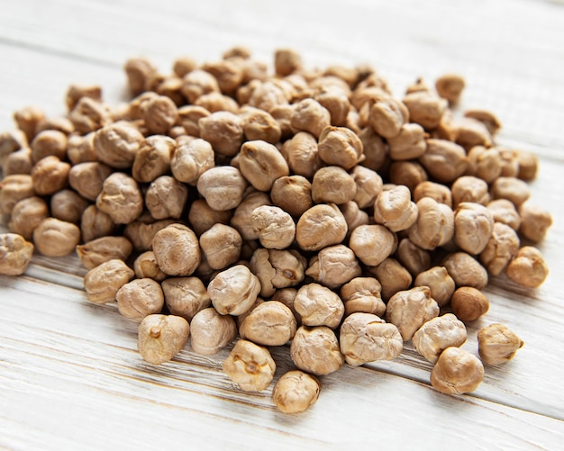 Uncooked dried chickpeas on a old wooden table