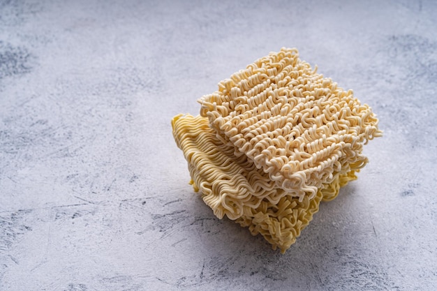 uncooked dry instant noodles or ramen isolated on white abstract background