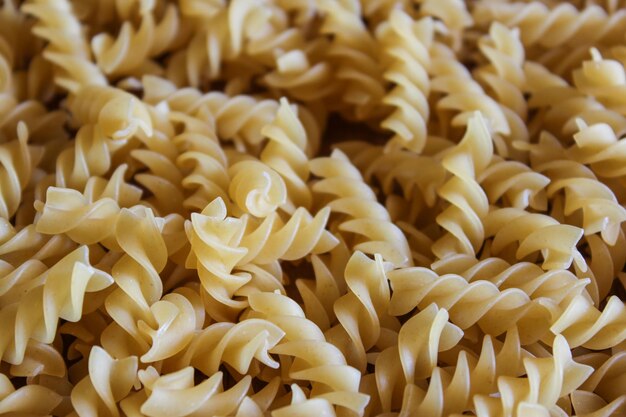 Uncooked fusilli pasta background