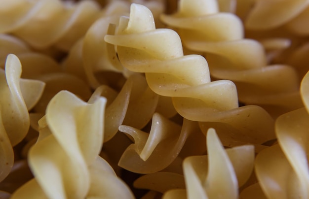 Uncooked fusilli pasta background