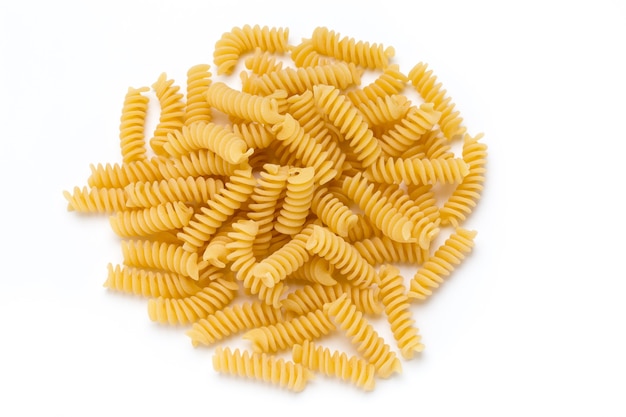 Uncooked fusilli pasta isolated white.