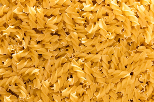 Uncooked fusilli pasta  texture background